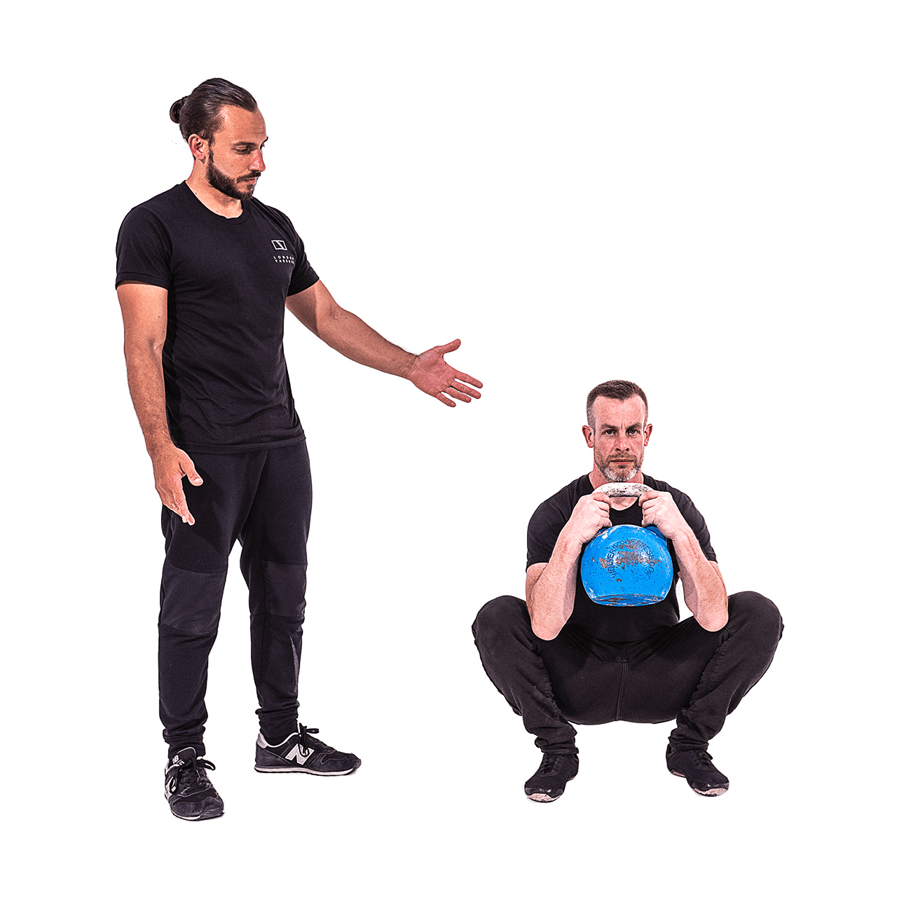 Kevin teaches Andy a kettlebell squat.